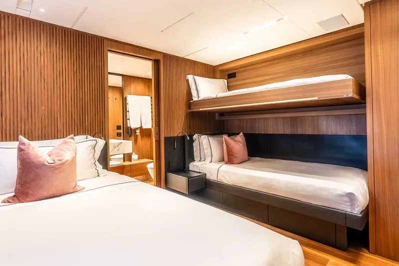 Neverland Yacht Photos Pics Luxurious Sanlorenzo 44 Alloy 2020 yacht cabin with modern wood paneling and cozy bedding.