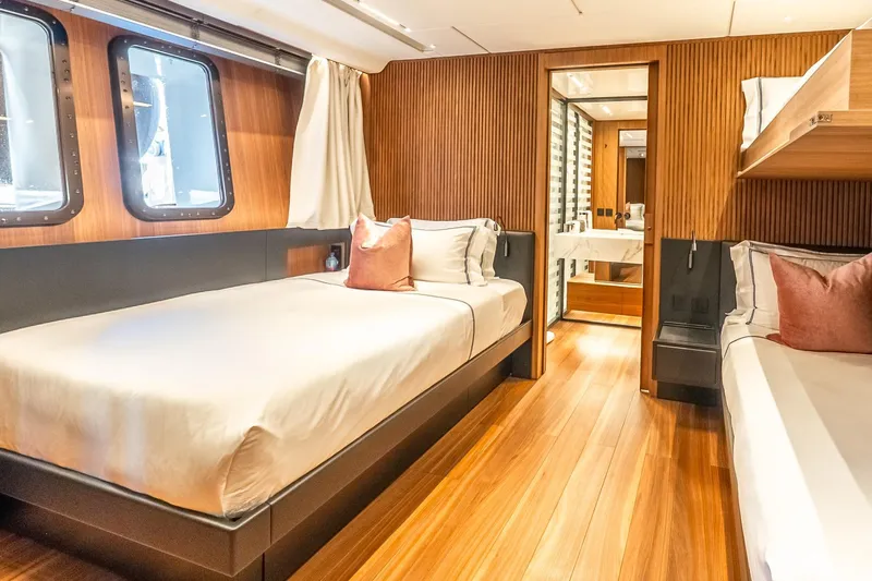Neverland Yacht Photos Pics Luxurious 2020 Sanlorenzo 44 Alloy yacht cabin with twin beds and elegant wood paneling.