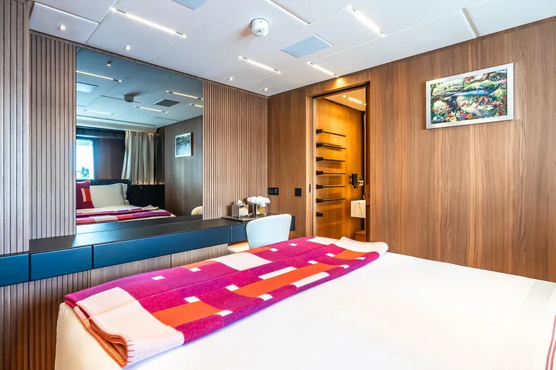 Neverland Yacht Photos Pics Luxurious Sanlorenzo 44 Alloy 2020 yacht bedroom with modern wood paneling and vibrant decor.