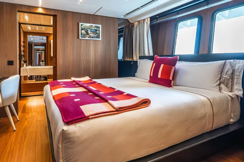 Neverland Yacht Photos Pics Luxurious bedroom interior on 2020 Sanlorenzo 44 Alloy yacht, featuring modern design and vibrant decor.