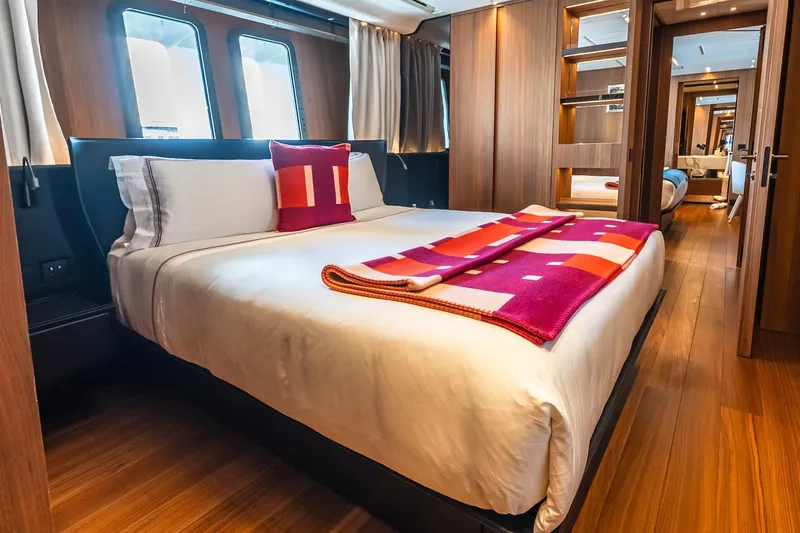 Neverland Yacht Photos Pics Luxurious bedroom interior on 2020 Sanlorenzo 44 Alloy yacht, featuring elegant wood finishes.