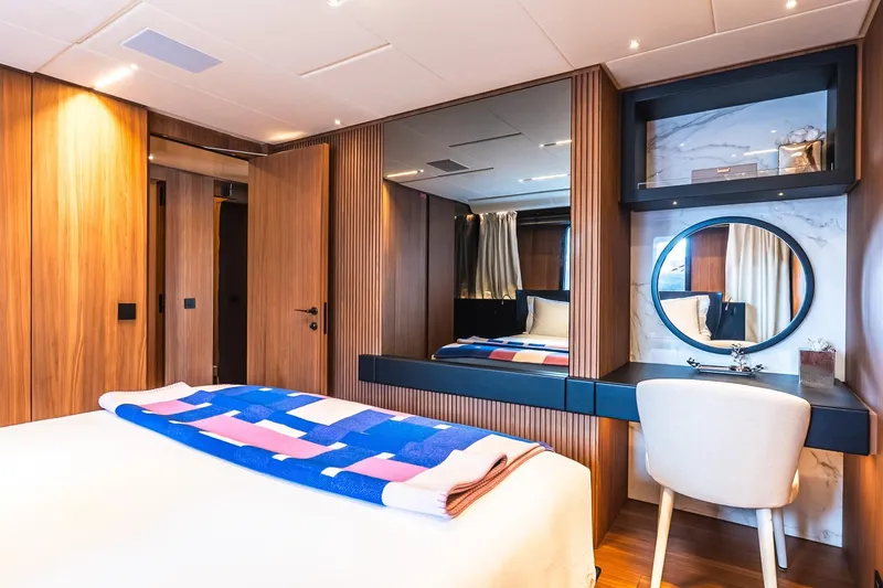 Neverland Yacht Photos Pics Luxurious Sanlorenzo 44 Alloy 2020 yacht bedroom with modern wood paneling and elegant decor.