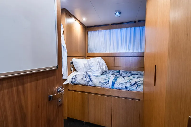 Neverland Yacht Photos Pics Cozy cabin interior on 2020 Sanlorenzo 44 Alloy yacht with wooden finish and bedding.