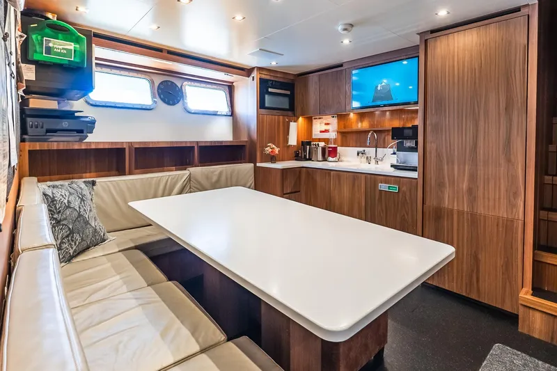 Neverland Yacht Photos Pics Luxurious interior of 2020 Sanlorenzo 44 Alloy yacht with modern kitchen and seating area.