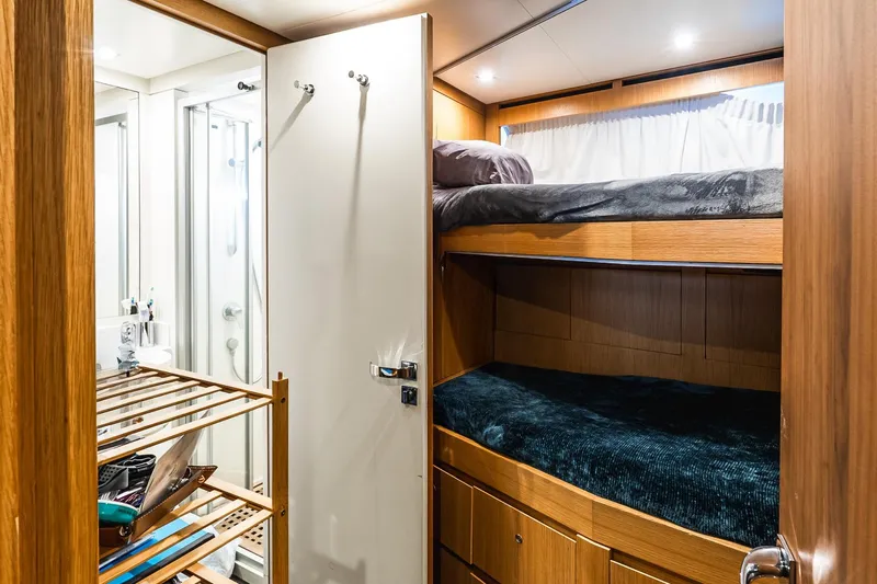 Neverland Yacht Photos Pics Luxurious Sanlorenzo 44 Alloy 2020 yacht cabin with bunk beds and modern bathroom.
