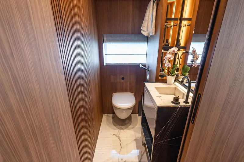 Neverland Yacht Photos Pics Luxurious bathroom on 2020 Sanlorenzo 44 Alloy yacht with modern wood paneling and elegant fixtures.