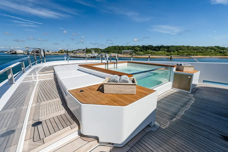 Neverland Yacht Photos Pics Luxurious 2020 Sanlorenzo 44 Alloy yacht deck with pool, docked by scenic shoreline.