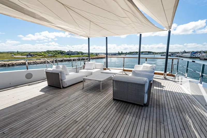 Neverland Yacht Photos Pics Luxurious Sanlorenzo 44 Alloy yacht deck with elegant seating, ocean view, and sunshade, 2020 model.