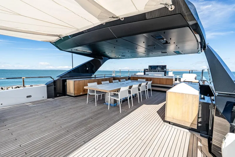 Neverland Yacht Photos Pics Luxurious 2020 Sanlorenzo 44 Alloy yacht deck with dining area and ocean view.