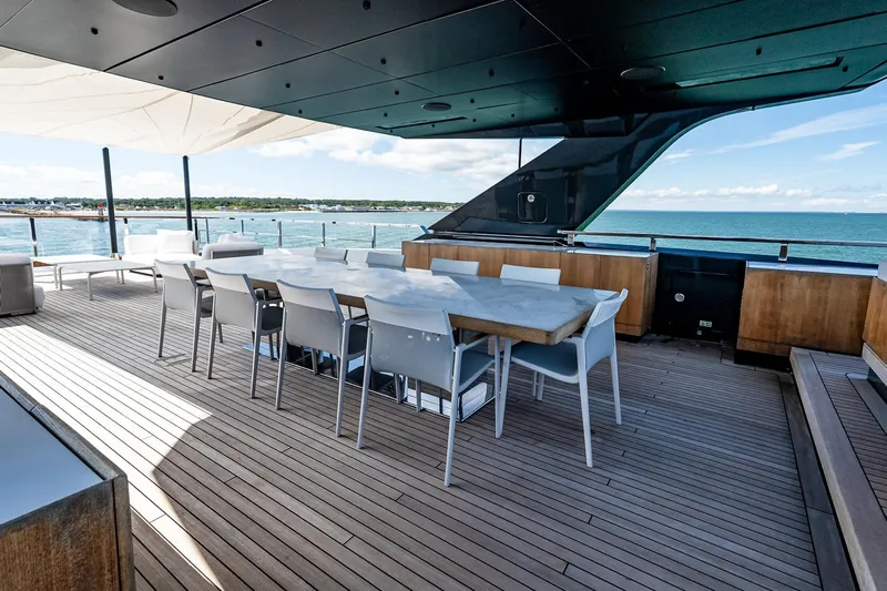 Neverland Yacht Photos Pics Luxurious 2020 Sanlorenzo 44 Alloy yacht deck with dining area and ocean view.
