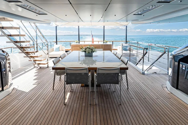 Neverland Yacht Photos Pics Luxurious Sanlorenzo 44 Alloy yacht deck with elegant dining area, ocean view, and modern design.