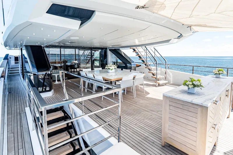 Neverland Yacht Photos Pics Luxurious Sanlorenzo 44 Alloy yacht deck, 2020 model, featuring elegant dining area and ocean views.