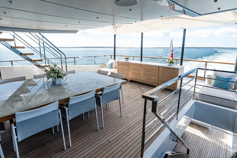 Neverland Yacht Photos Pics Luxurious Sanlorenzo 44 Alloy yacht deck with elegant dining area, ocean view, and modern design.