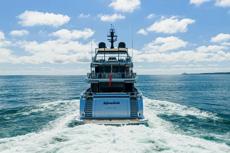 Neverland Yacht Photos Pics Sanlorenzo 44 Alloy yacht cruising on open sea under a clear blue sky, 2020 model.