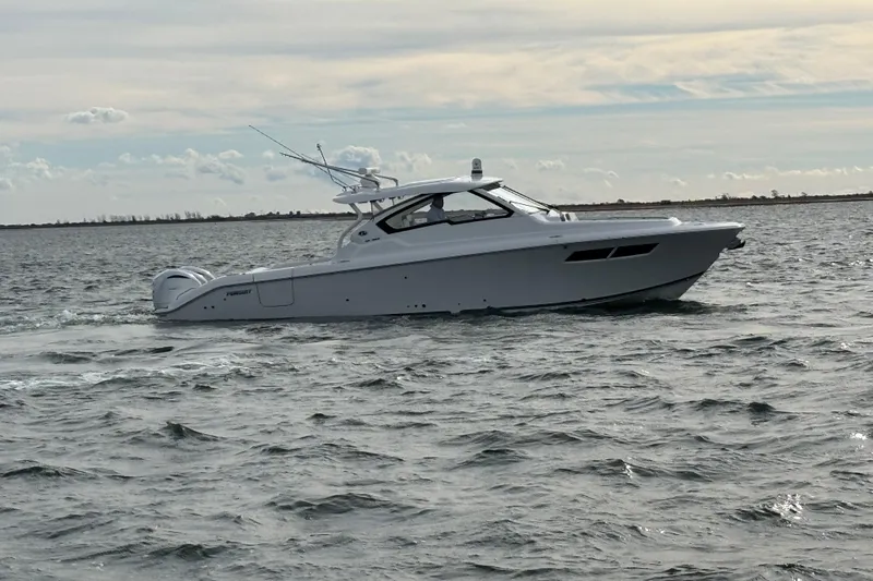  Yacht Photos Pics 2022 Pursuit DC 365 Dual Console boat cruising on open water.