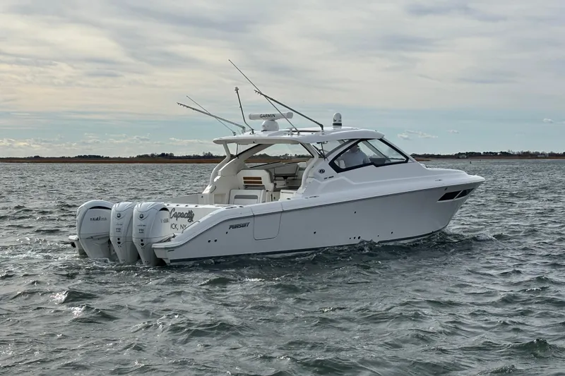  Yacht Photos Pics 2022 Pursuit DC 365 Dual Console boat cruising on open water.