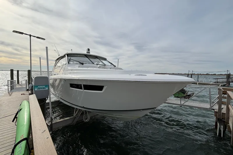  Yacht Photos Pics 2022 Pursuit DC 365 Dual Console boat docked on a sunny day.