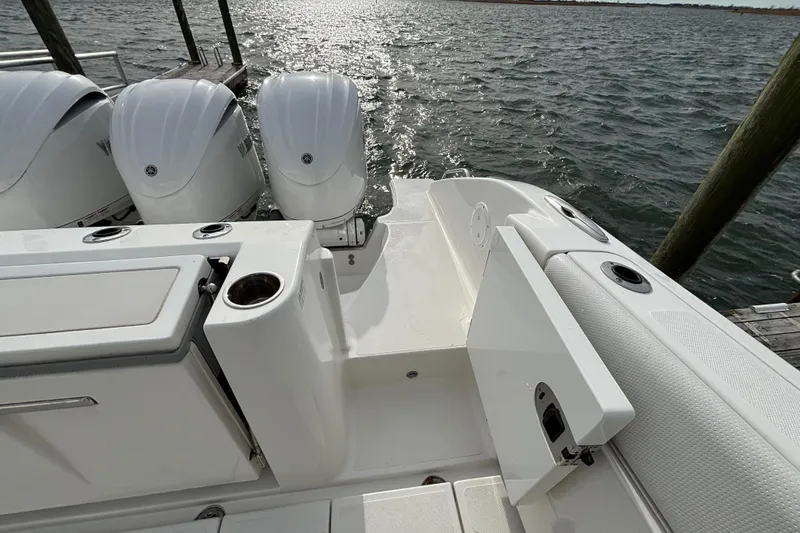  Yacht Photos Pics 2022 Pursuit DC 365 Dual Console boat with triple outboard engines on water.