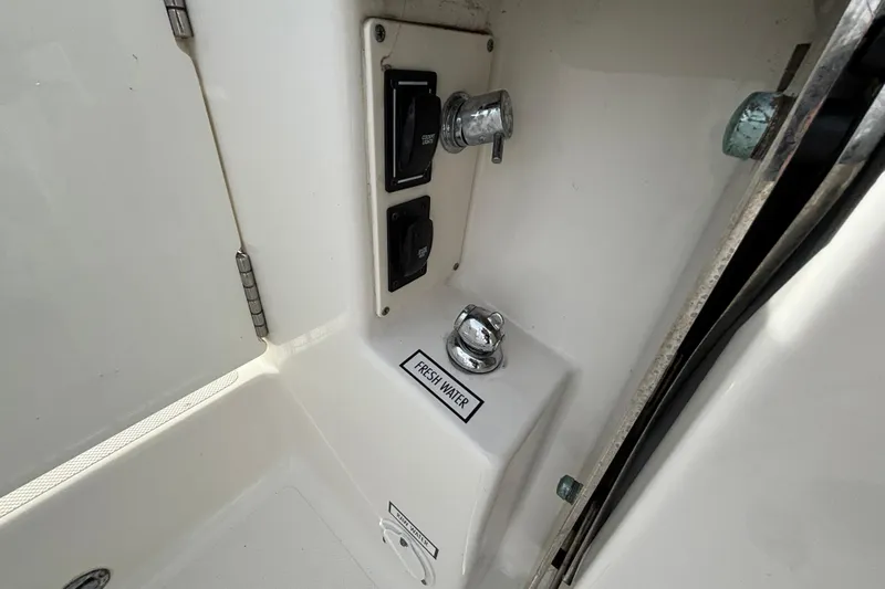  Yacht Photos Pics 2022 Pursuit DC 365 Dual Console boat interior with fresh water control panel.