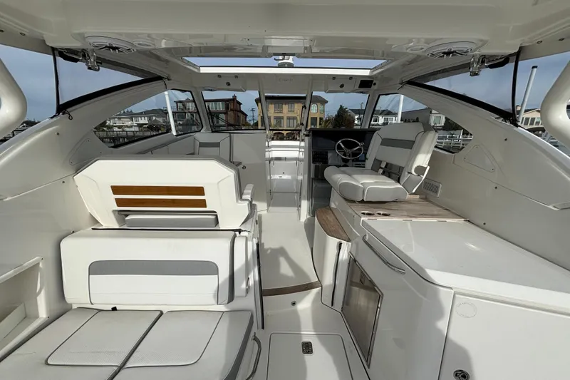  Yacht Photos Pics 2022 Pursuit DC 365 Dual Console boat interior with seating and helm station.