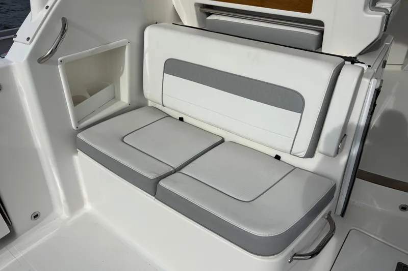  Yacht Photos Pics 2022 Pursuit DC 365 Dual Console boat seating area with white and gray cushions.