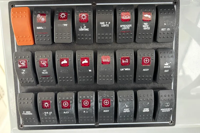  Yacht Photos Pics Control panel of a 2022 Pursuit DC 365 Dual Console boat with labeled switches.