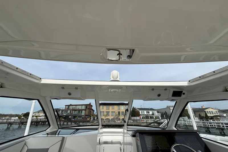  Yacht Photos Pics 2022 Pursuit DC 365 Dual Console boat interior with waterfront view.