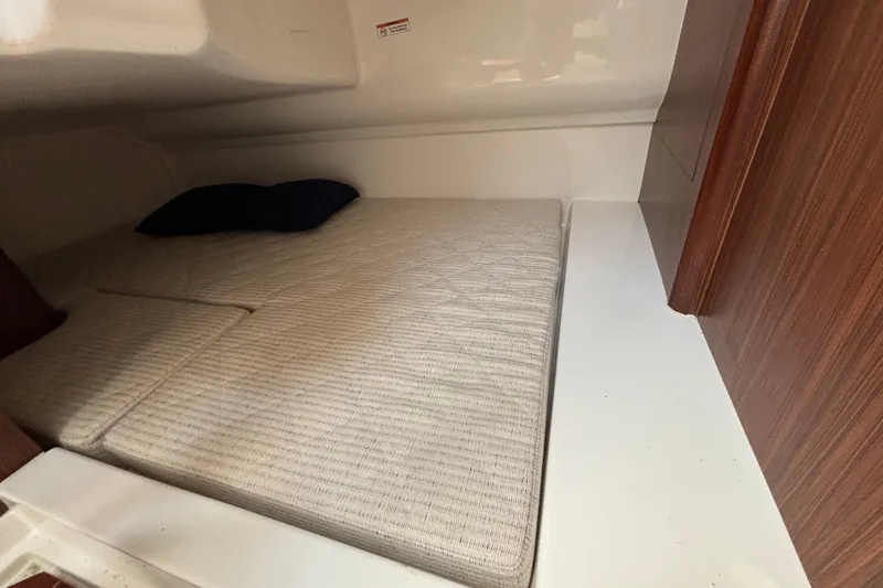  Yacht Photos Pics 2022 Pursuit DC 365 Dual Console cabin interior with bed and pillow.