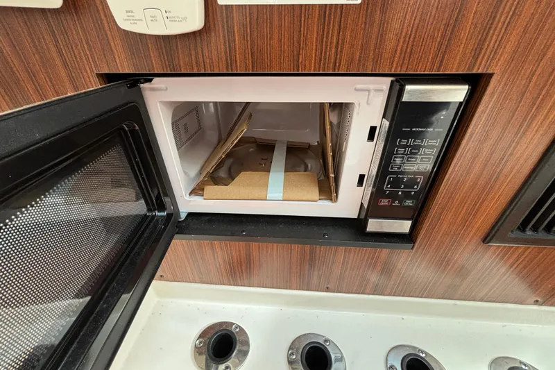  Yacht Photos Pics Microwave in 2022 Pursuit DC 365 Dual Console boat, open with packaging inside.