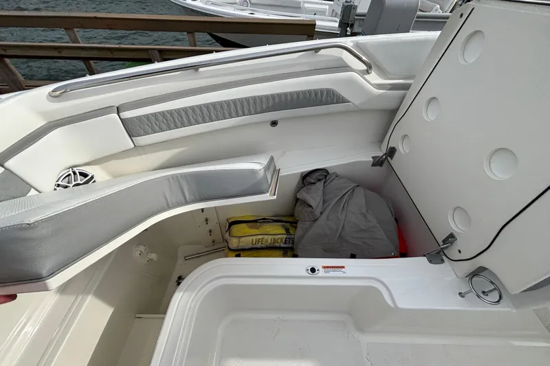  Yacht Photos Pics 2022 Pursuit DC 365 Dual Console boat storage compartment with life jackets and gear.