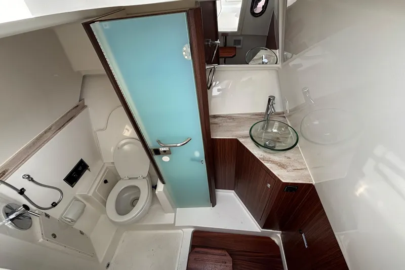 Yacht Photos Pics 2022 Pursuit DC 365 Dual Console bathroom with modern fixtures and glass sink.
