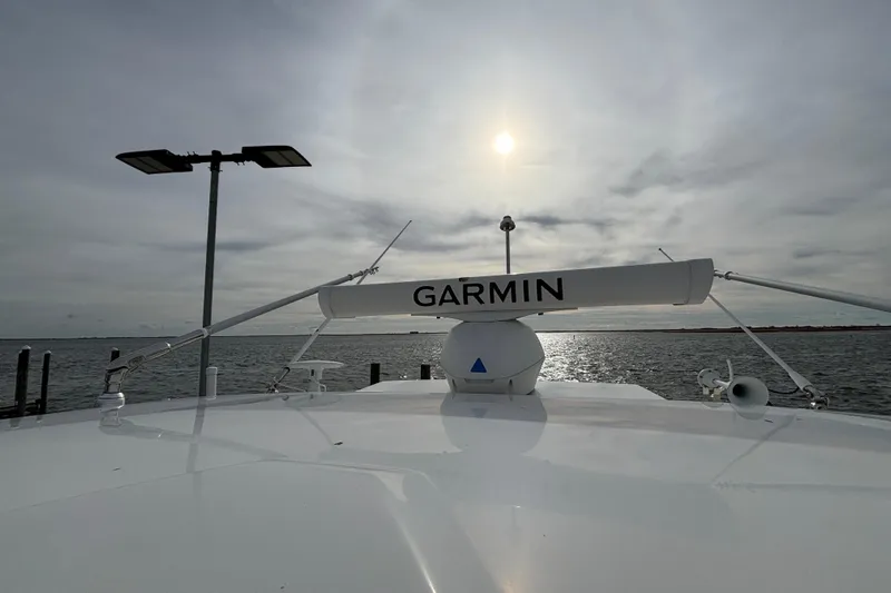  Yacht Photos Pics 2022 Pursuit DC 365 Dual Console boat with Garmin radar on a sunny day at sea.