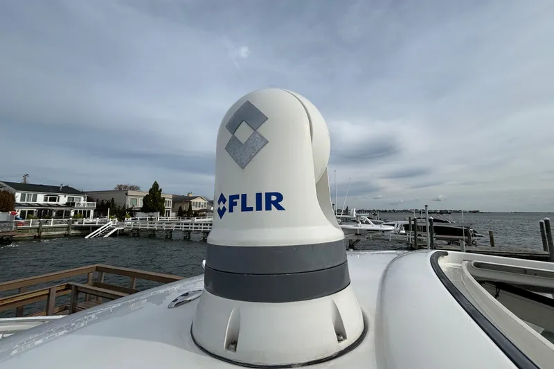  Yacht Photos Pics FLIR camera on 2022 Pursuit DC 365 Dual Console boat, docked by waterfront homes.