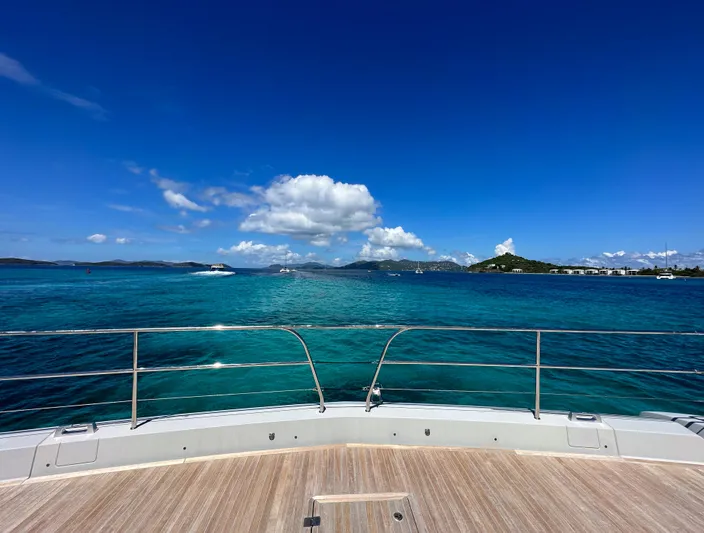  Yacht Photos Pics View from the deck of a 2022 Lagoon SIXTY 7 yacht on clear blue waters.