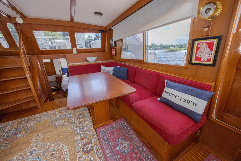  Yacht Photos Pics Interior of 1989 Offshore Yachts 48 Yachtfisher with red seating and wooden accents.
