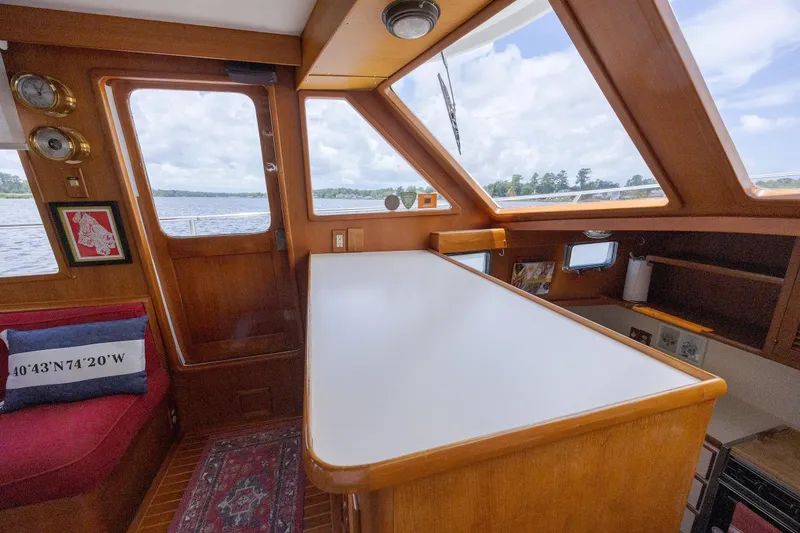  Yacht Photos Pics Interior of 1989 Offshore Yachts 48 Yachtfisher with wood finish and large windows.