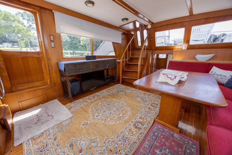  Yacht Photos Pics Interior of 1989 Offshore Yachts 48 Yachtfisher with wood paneling and red seating.