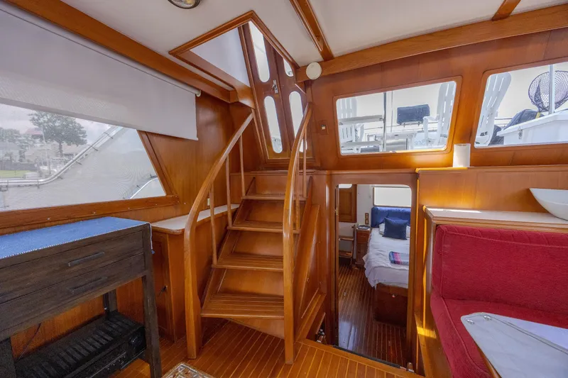  Yacht Photos Pics Interior of 1989 Offshore Yachts 48 Yachtfisher with wooden stairs and cozy cabin.