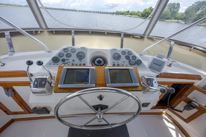  Yacht Photos Pics Helm of 1989 Offshore Yachts 48 Yachtfisher with navigation equipment and steering wheel.