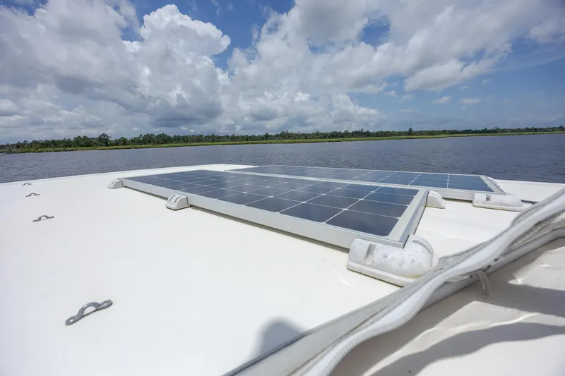  Yacht Photos Pics Solar panels on 1989 Offshore Yachts 48 Yachtfisher, under a partly cloudy sky.