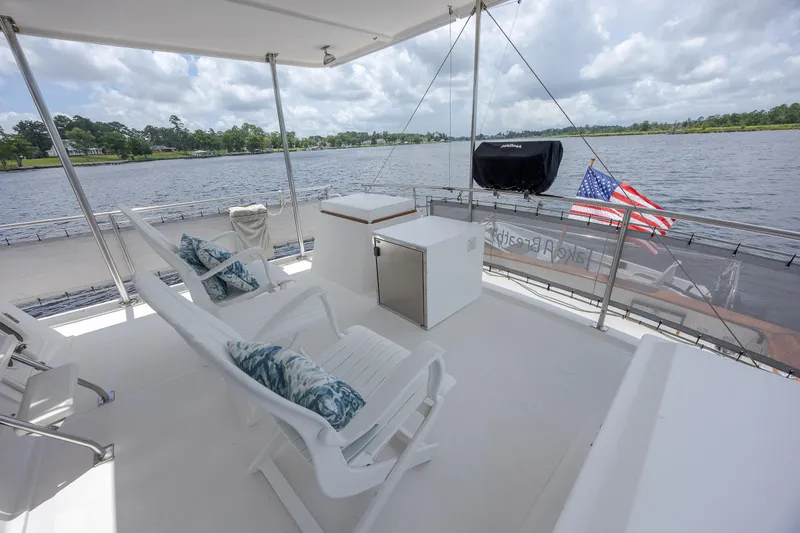  Yacht Photos Pics Spacious deck of 1989 Offshore Yachts 48 Yachtfisher with seating and scenic water view.