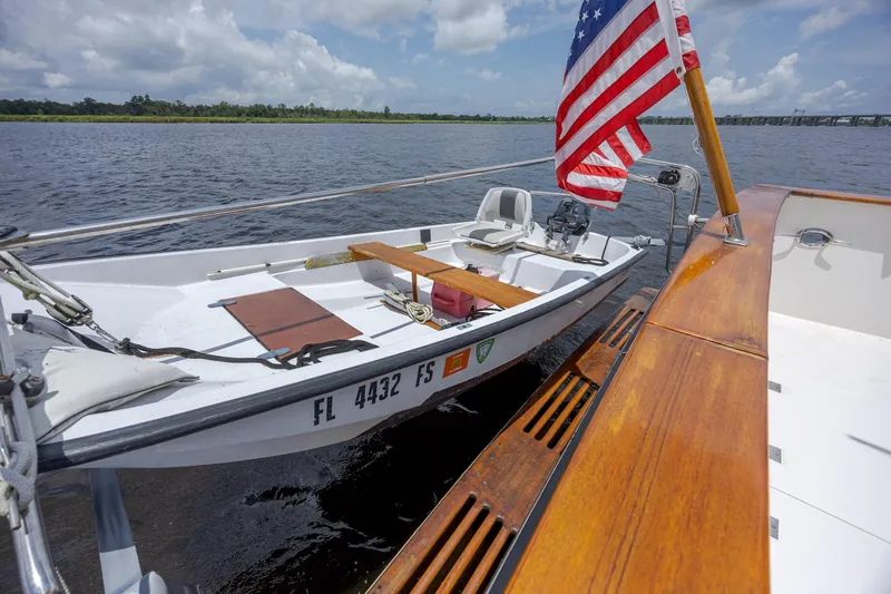  Yacht Photos Pics 1989 Offshore Yachts 48 Yachtfisher with American flag, docked on calm water.