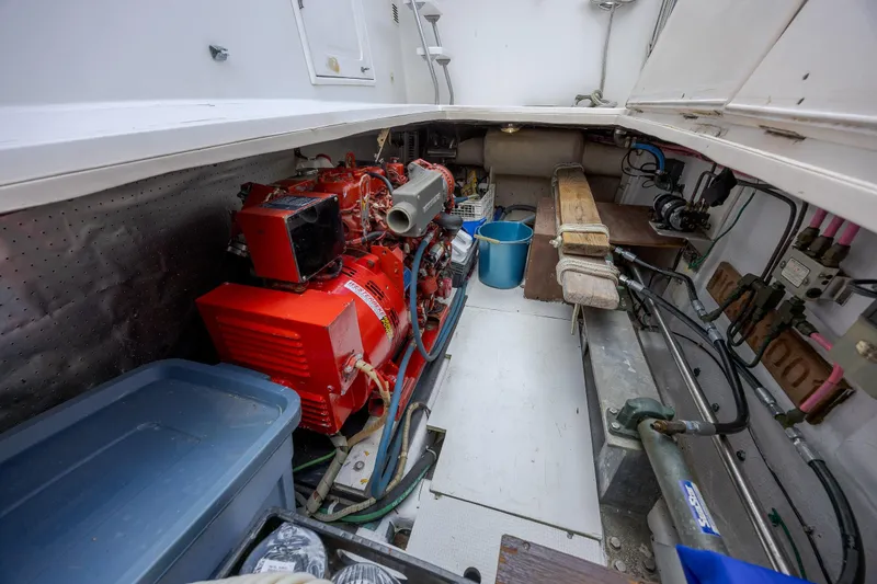  Yacht Photos Pics Engine room of 1989 Offshore Yachts 48 Yachtfisher with red generator and storage.