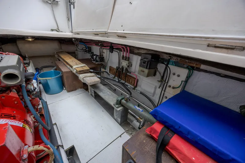  Yacht Photos Pics Engine room of 1989 Offshore Yachts 48 Yachtfisher, showing equipment and storage.