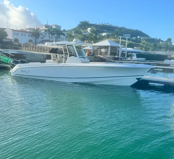  Yacht Photos Pics 2017 Boston Whaler 330 Outrage docked in a scenic marina setting.