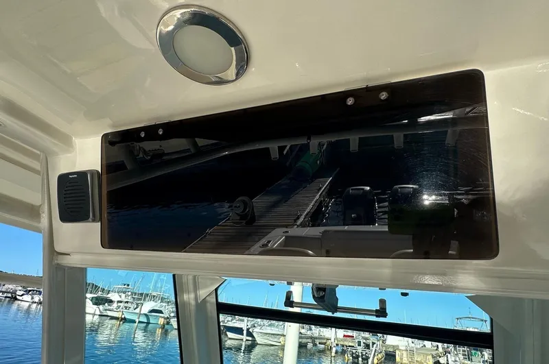  Yacht Photos Pics 2017 Boston Whaler 330 Outrage interior with marina view through window.