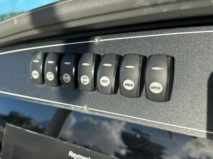  Yacht Photos Pics Control panel switches on a 2017 Boston Whaler 330 Outrage boat dashboard.