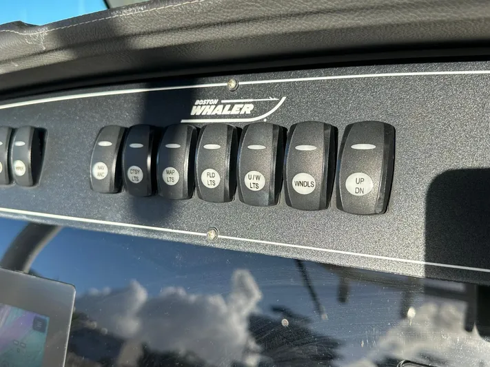  Yacht Photos Pics Control panel of a 2017 Boston Whaler 330 Outrage boat with labeled switches.