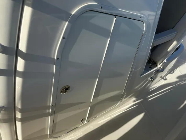  Yacht Photos Pics 2017 Boston Whaler 330 Outrage boat compartment door in sunlight.