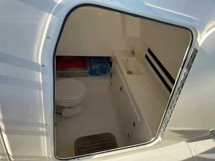  Yacht Photos Pics 2017 Boston Whaler 330 Outrage boat interior with toilet and sink.